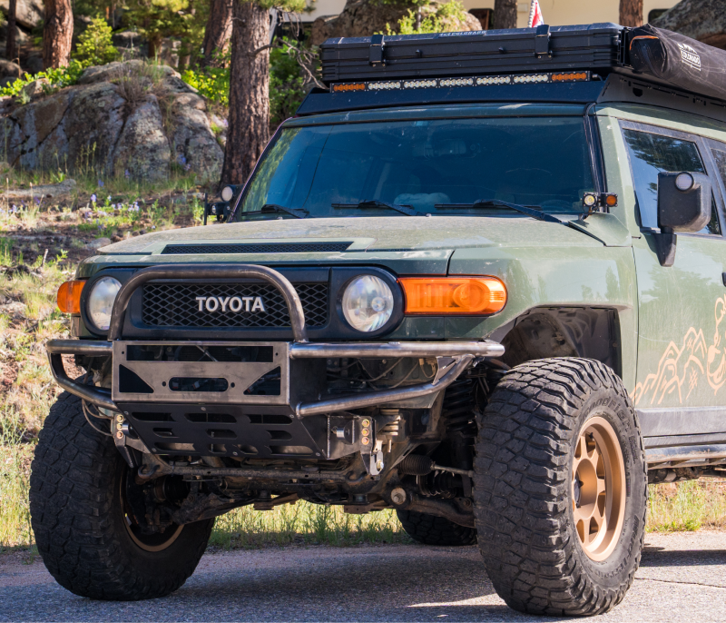 Toyota FJ Cruiser featuring a robust offroad bumper, designed for extreme durability and trail performance, photographed in a rugged outdoor landscape, ideal for offroad enthusiasts and overlanding adventures.