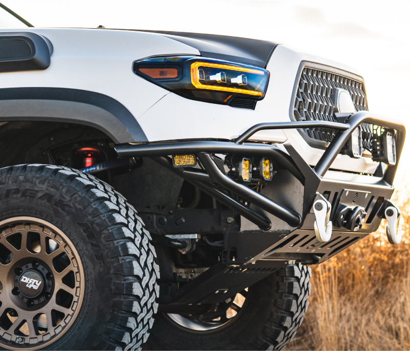 Toyota Tacoma outfitted with a durable offroad bumper, built for strength and adventure, captured in a rugged outdoor environment, highlighting its trail-ready capabilities